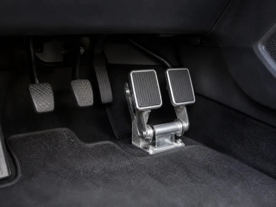 Dual-brake pedals on the instructor side of a training vehicle